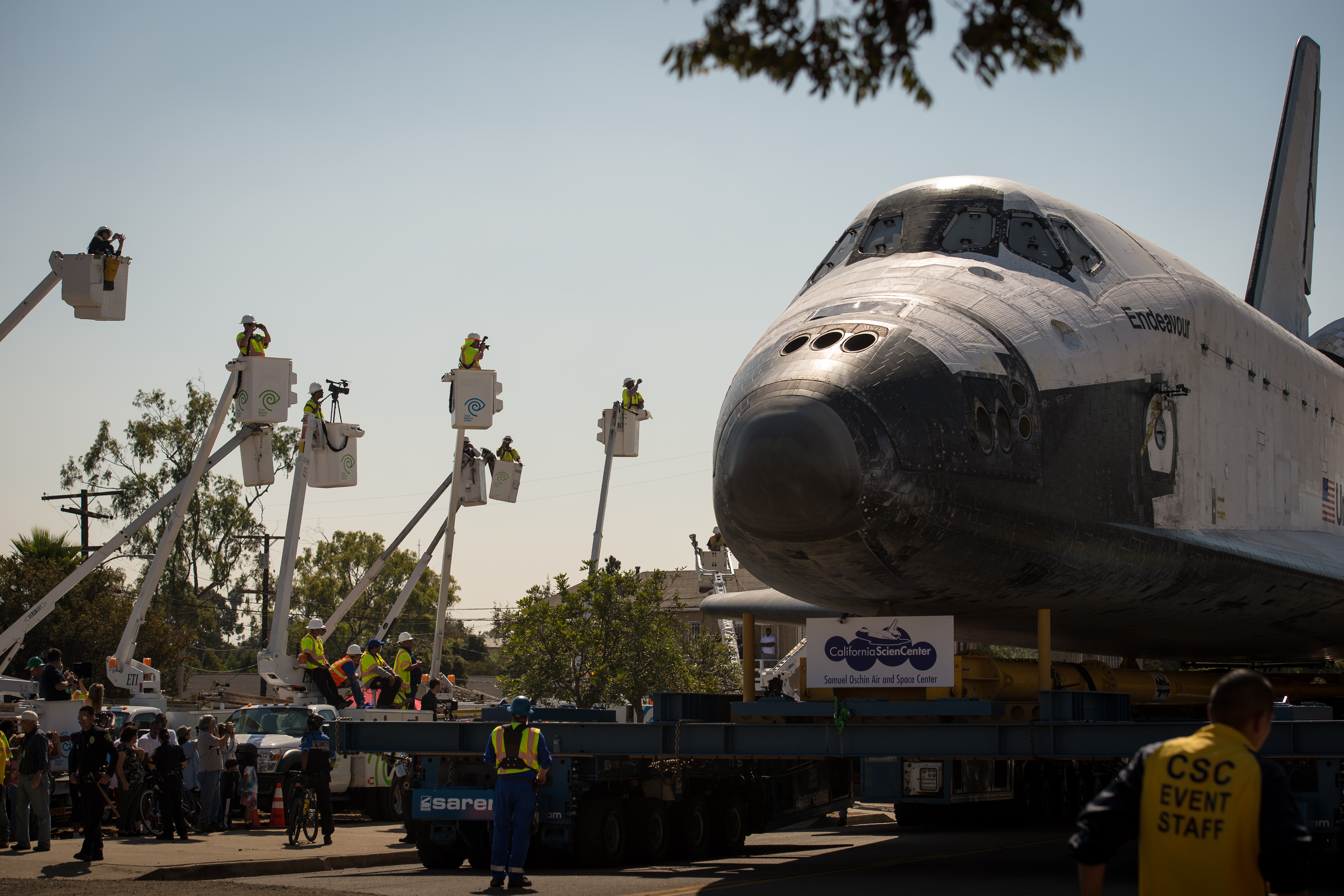 Endeavour on a Los Angeles street, with workers in lifts to get a better look at the scene