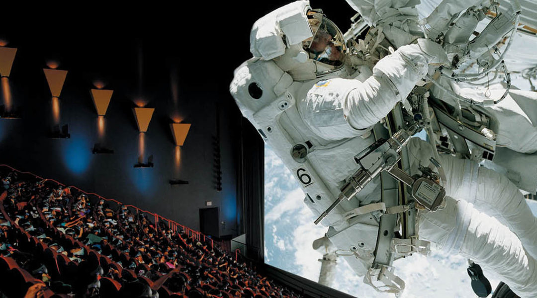 Audience inside IMAX Theater watching a movie featuring an astronaut