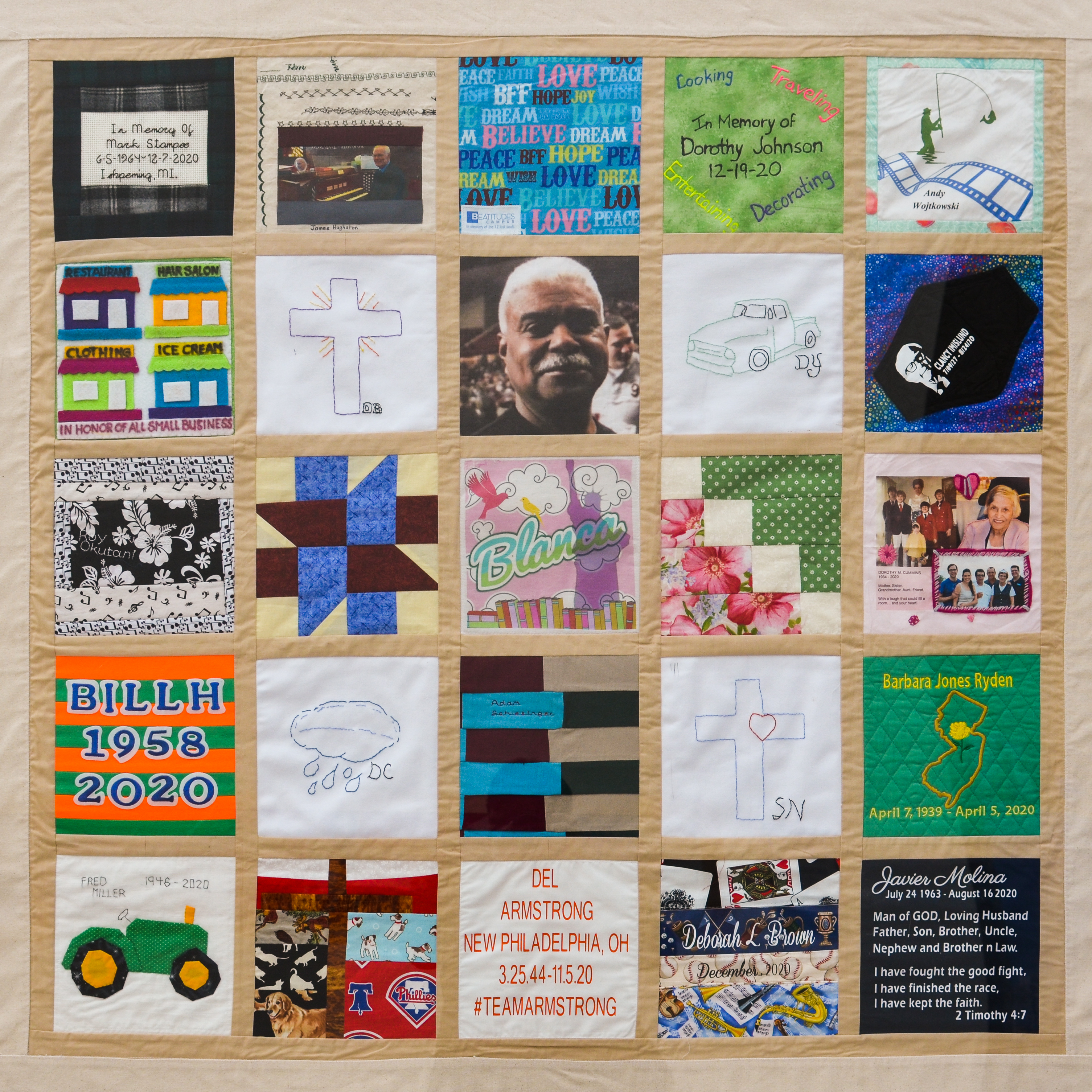 This colorful panel of the COVID-19 memorial quilt features 25 homemade fabric squares sewn in a five-by-five grid