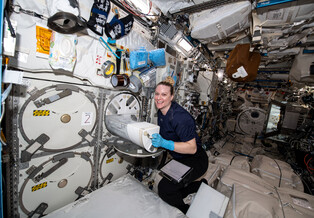 Astronaut Kate Rubins loads tissue samples into a freezer on the International Space Station.