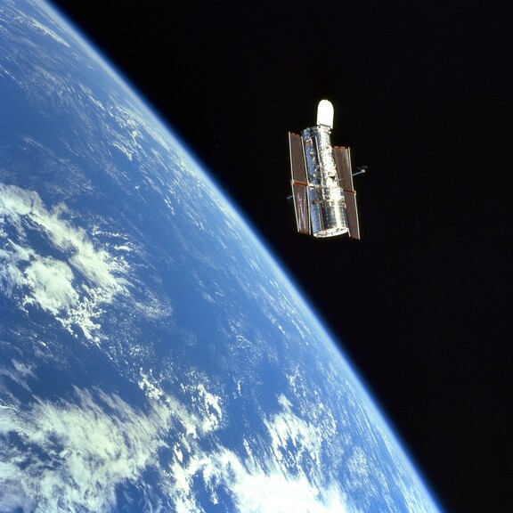 The Hubble space telescope orbits above Earth.