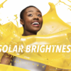 Image of yellow paint splashed around an African American woman with the words "solar brightness" on the photo