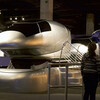 Children gather around silver motion simulators in the Endeavour Together exhibit gallery