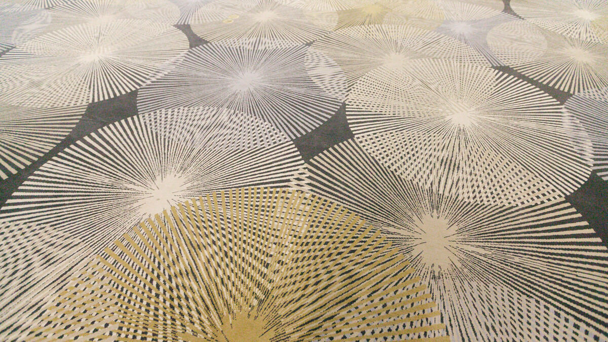 Loker Conference Center carpeting featuring gold and off-white layered starbursts on solid plum.