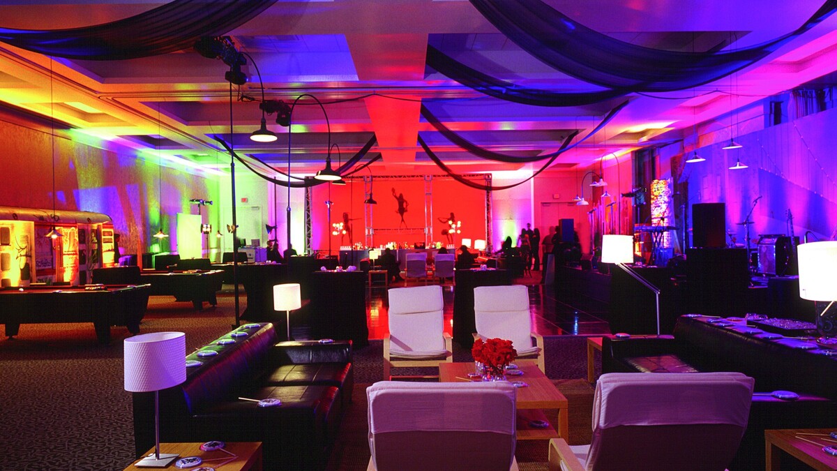Loker Conference Center turned Night Club for gala afterparty featuring dancefloor, lounge furniture, pool tables, dancers, and multicolored lighting