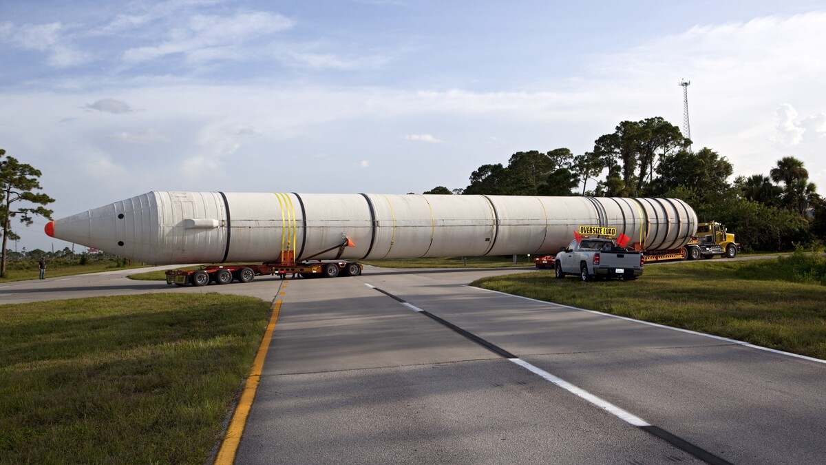 A space shuttle solid rocket booster is being transported by truck to California.