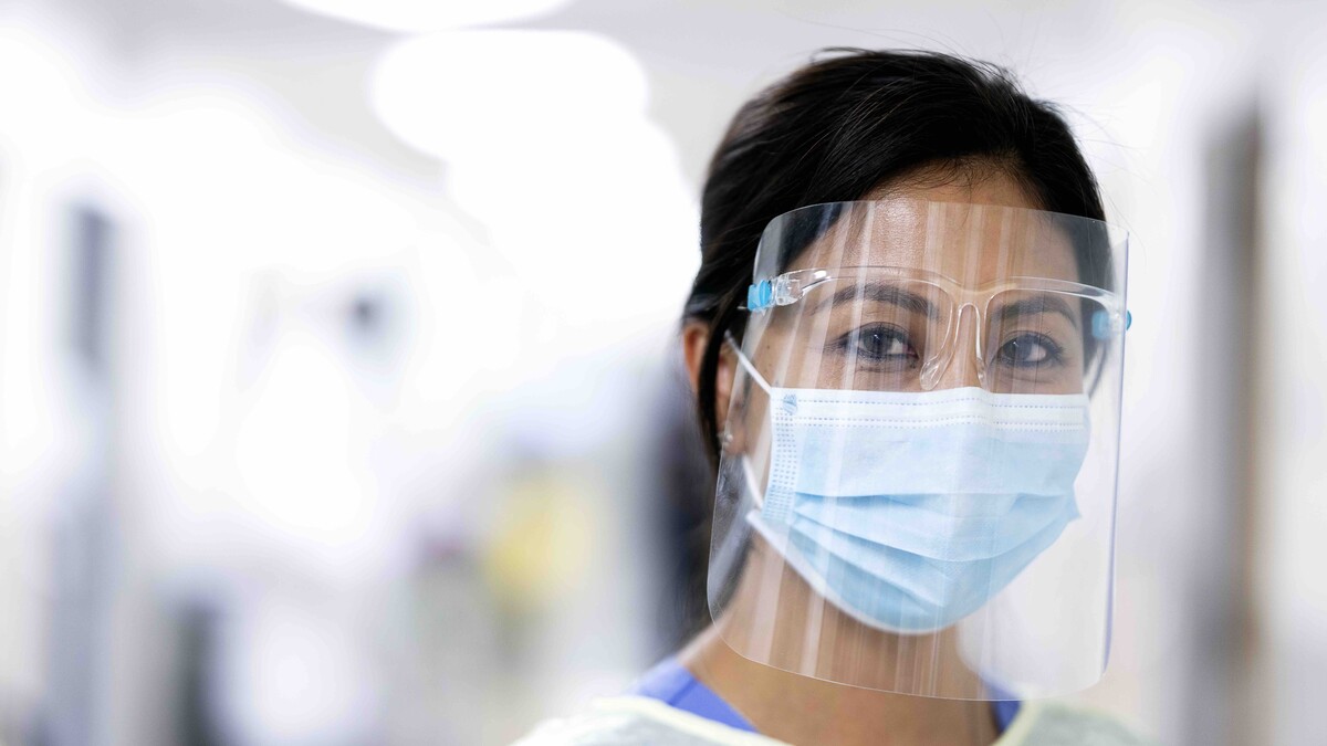 Registered nurse Sophanet Nhoung looks directly at the camera while dressed in full personal protective equipment