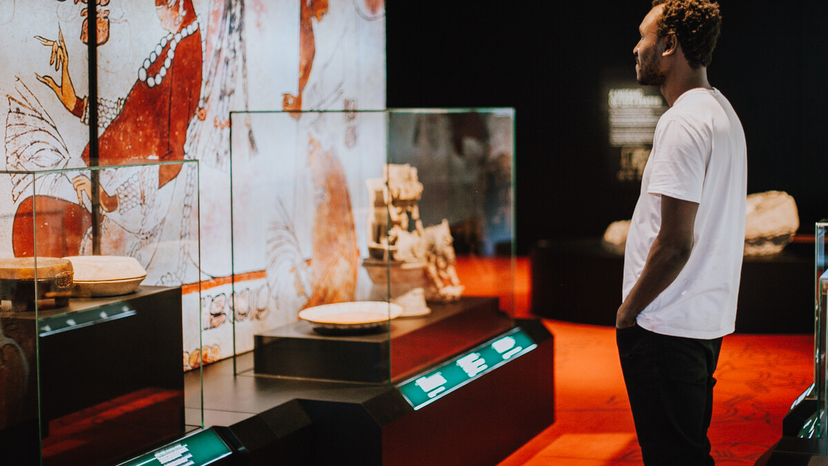 Guest admires artifacts in the Maya exhibition.