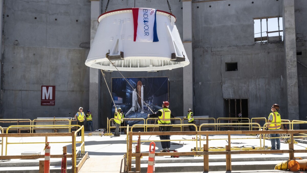 Aft Skirt with flag being lowered onto the Seismic Isolator Pad