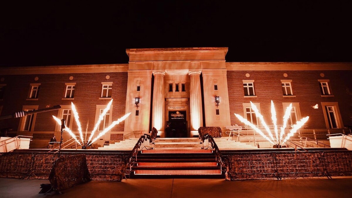 Wallis Annenberg Building exterior featuring active pyrotechnics on either side of the entrance.