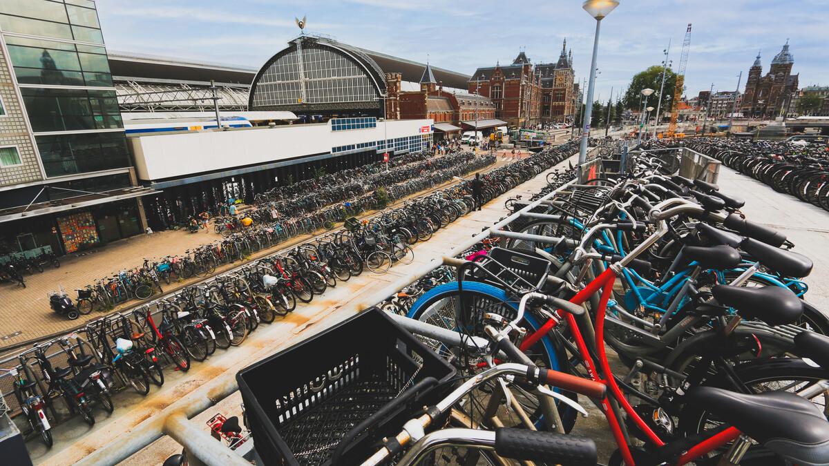 A high density of bicycles are stored outside of a museum in Amsterdam.