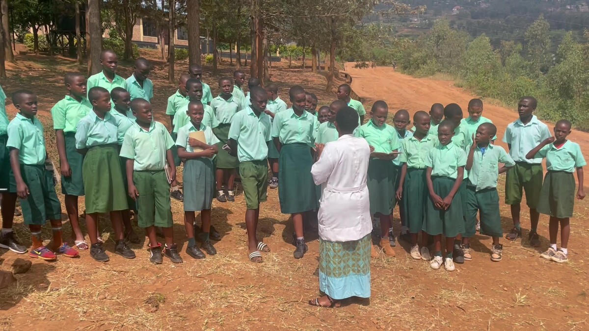 Rwanda school students and teacher standing outside