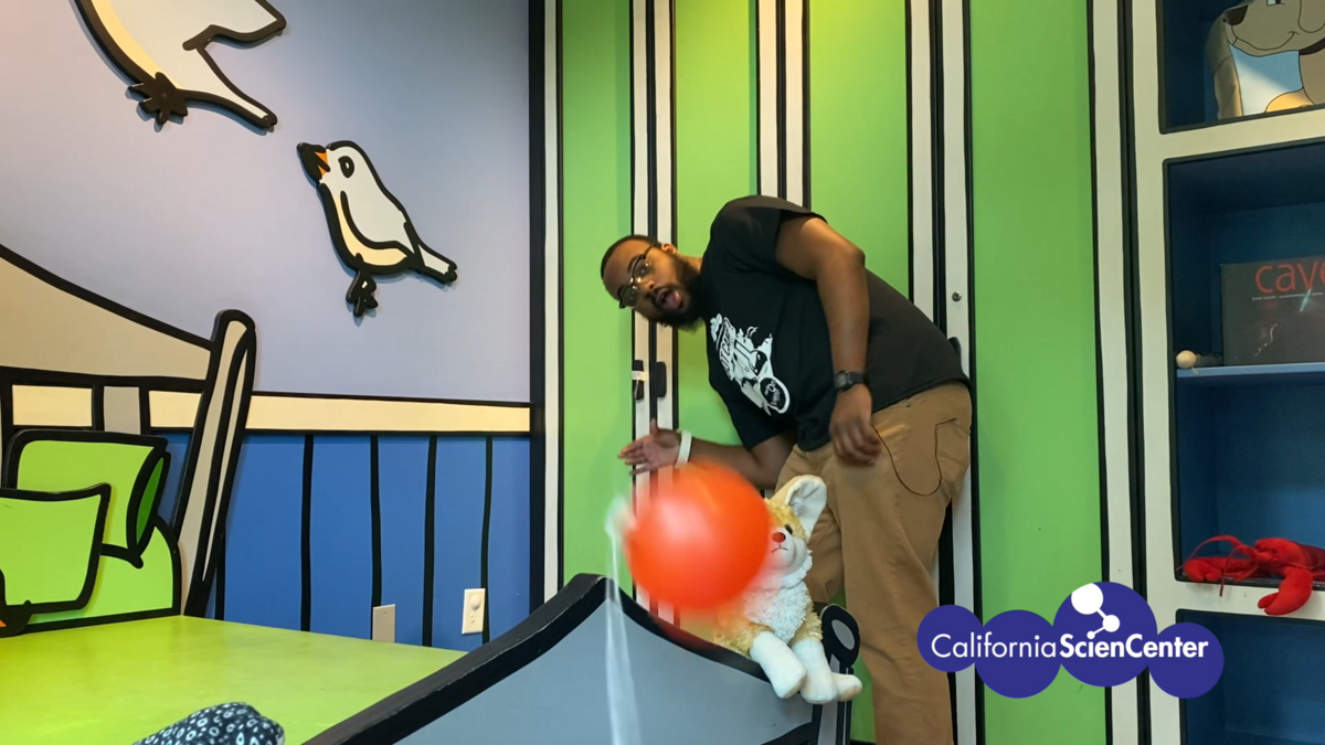 Educator Reggie testing balloon rocket.