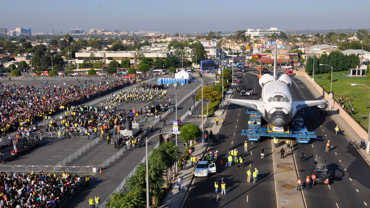 Endeavour driving down the streets of Los Angeles, with crowds gathered to watch