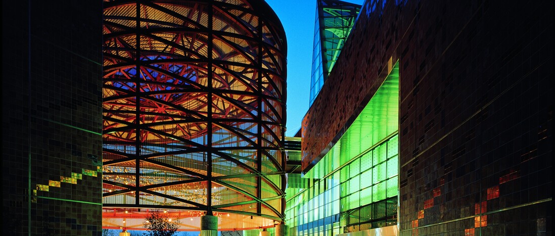 Empty Lorsch Family Pavilion, California Science Center front entrance, dramatically lit at night