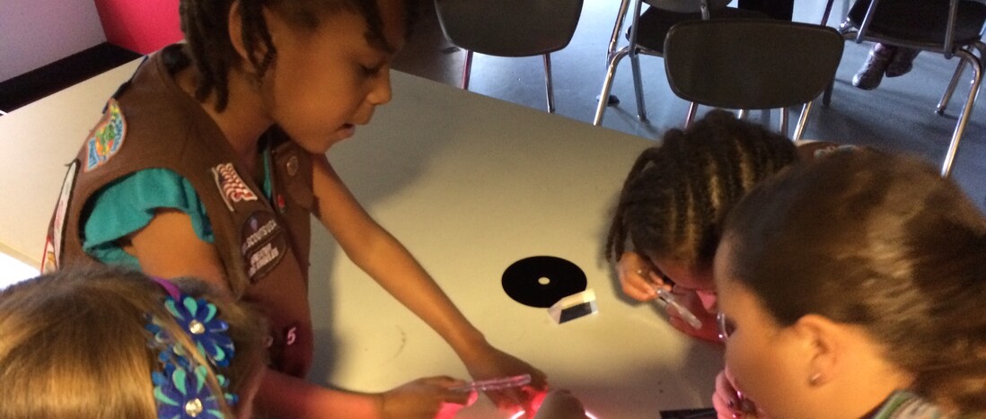 Girl Scouts testing lights and optics during a Scout Day